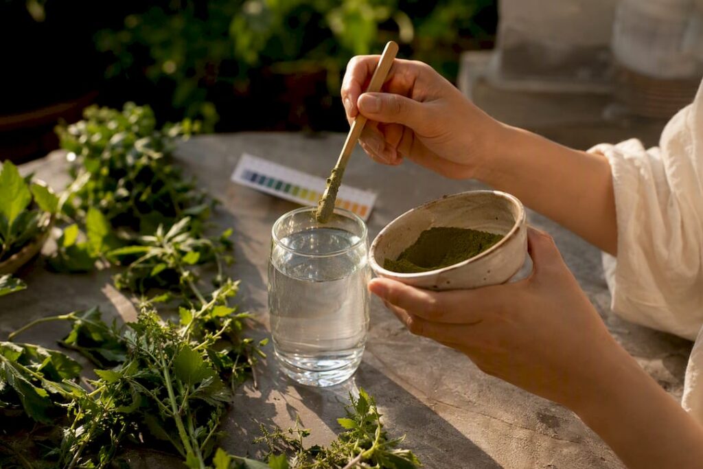 Hands mixing alkaline herbs with water